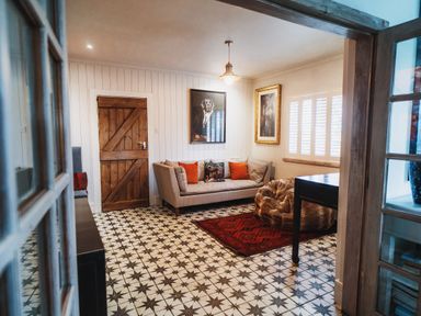 A living room with a sofa and table at Glanllyn Bach in Llanfaelog