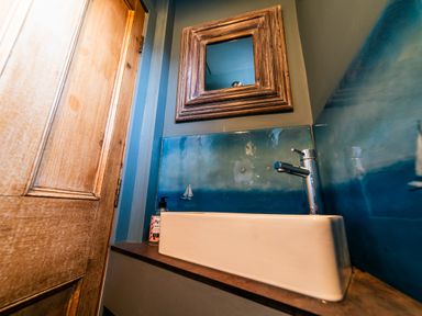 A bathroom with a sink and mirror at Glanllyn Bach in Llanfaelog
