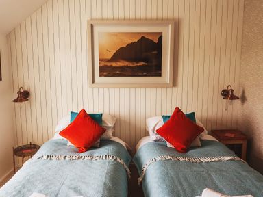 A bedroom with two beds arranged side by side at Glanllyn Bach Llanfaelog