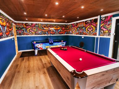 A game room with a pool table and an air hockey table at Glanllyn Bach in Llanfaelog