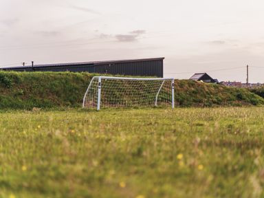 A soccer goalpost on a grassy field at Glanllyn Bach in Llanfaelog