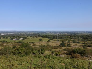 A landscape view with fields and trees near Ceunant, Tan Y Merddyn