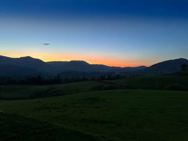 A landscape with hills and grass under a sunset sky at Ty Dyffryn in Llan Ffestiniog