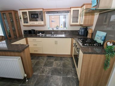 A kitchen with a sink and appliances at Gentle Tide Hasguard Cross near Little Haven