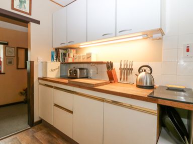 A kitchen countertop with bread bin toaster kettle and knives at Loanview in Cornhill-On-Tweed
