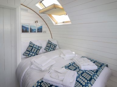 A bedroom with a bed towels and pillows under a skylight at Moel Famau in Bryniau Clwyd near Denbigh