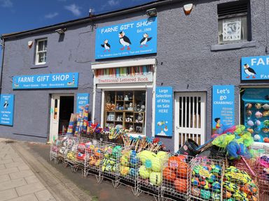 The exterior of Farne Gift Shop with toys sports balls and nets displayed outside at Farne Gift Shop in Seahouses
