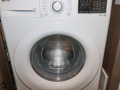 A front-loading washing machine with control dial and digital display at Tickeydoo Tor Down Quarry St Breward