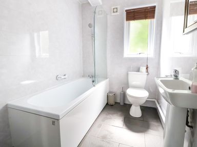 A bathroom with a bathtub shower toilet and sink at The Buck in Llanerch Park near St Asaph