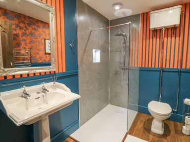 A bathroom with a pedestal sink a walk-in shower and a toilet at Llwynderw Hall in Abergwesyn near Llanwrtyd Wells