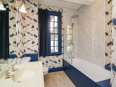 A bathroom with a bathtub shower toilet sink and window at Llwynderw Hall in Abergwesyn near Llanwrtyd Wells