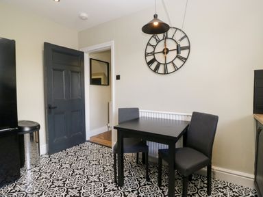 A dining room with a table and chairs at 5 Thornbarrow Road 