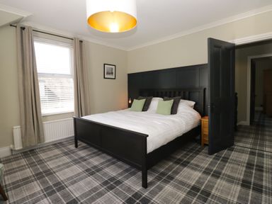 A bedroom with a bed and window at 5 Thornbarrow Road