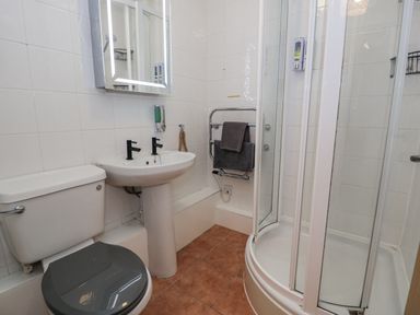 A bathroom with a sink and shower at Estuary Escape in Porthmadog