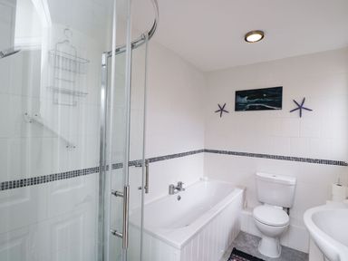 A bathroom with a shower enclosure bath toilet and sink at Ground Floor Annex in Milton-Under-Wychwood