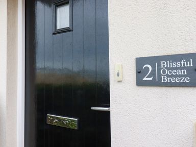 A front door with a sign at Blissful Ocean Breeze in Perranporth