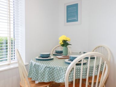 A dining room with a table and chairs at Blissful Ocean Breeze Perranporth