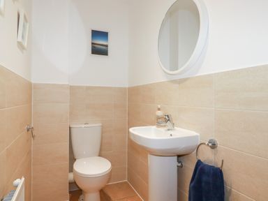 A bathroom with a toilet and a sink at Blissful Ocean Breeze in Perranporth