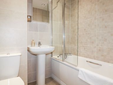 A bathroom with a sink, toilet, and bathtub at Blissful Ocean Breeze in Perranporth