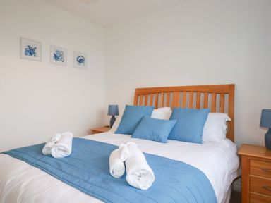 A bedroom with a bed and bedside lamps at Blissful Ocean Breeze Perranporth
