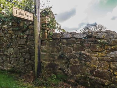 A sign with Lake View on a post next to a stone wall at Lake View Kestle Mill near Quintrell Downs