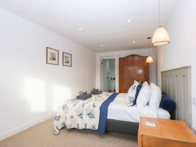 A bedroom with a bed and nightstand at Yr Hen Felin in Dyffryn Ardudwy