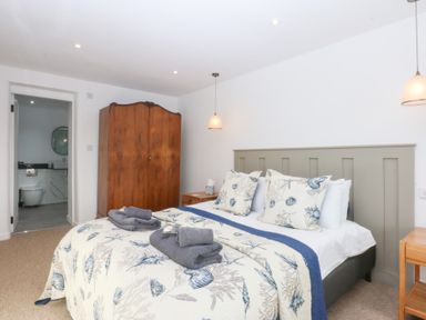 A bedroom with a bed and wardrobe at Yr Hen Felin Dyffryn Ardudwy