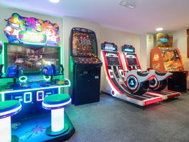 An arcade room with various game machines including shooting and racing games at Skylarks Trevellas Nr St Agnes