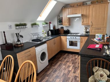 A kitchen with appliances and dining area at 20 Keay Heights St Austell