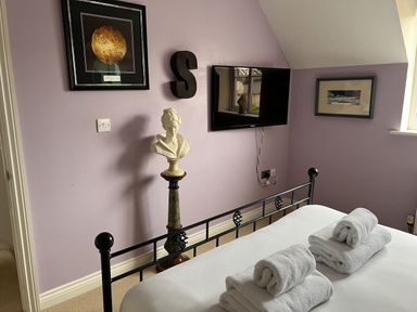 A bedroom with a bed and television at 20 Keay Heights St Austell