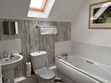 A bathroom with a bath, toilet, and sink at 20 Keay Heights St Austell