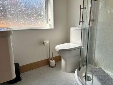 A bathroom with a sink, toilet and shower at The Swanage Rail Lookout in Swanage
