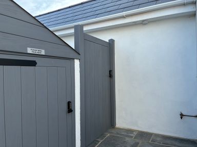 An outdoor area with a gray gate and wall at The Swanage Rail Lookout in Swanage