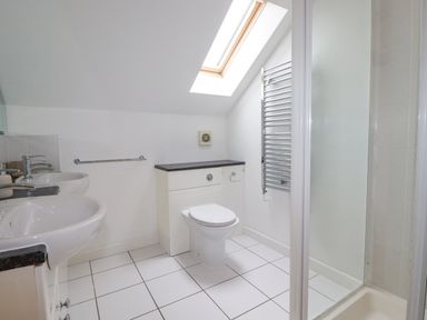 A bathroom with two sinks a toilet a towel rack and a shower at The Willows in Winnard's Perch near St Columb Major