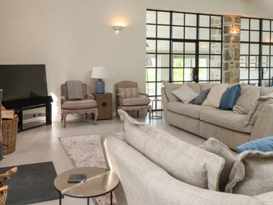 A living room with sofas chairs side tables and a television at Beudy Mawr in Cwmystradllyn near Tremadog