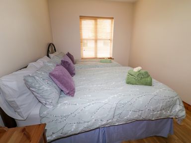 A bedroom with two beds pillows and folded towels on them at 46 Dunalinn Culdaff County Donegal