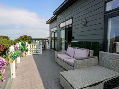 A deck with outdoor furniture at Coogee View in Maenygroes near New Quay