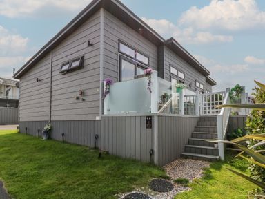A house with a deck and steps at Coogee View in Maenygroes near New Quay
