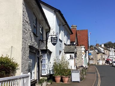 A street with stone and white buildings including The Old Lace Shop at Pebble Beach Chalet in Seaton