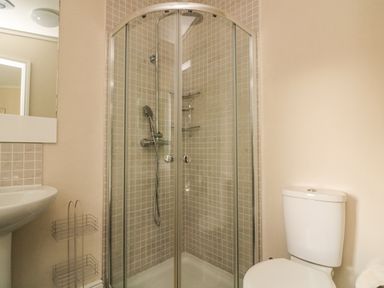 A bathroom with a glass enclosed shower a white toilet and a white sink at Deer Park 9 - Copse Corner Finlakes Holiday Park near Chudleigh