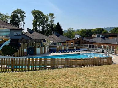 An outdoor swimming pool with lounge chairs and a water slide at Lodge 58 - Oak Tree Lodge in Finlakes Holiday Park near Chudleigh