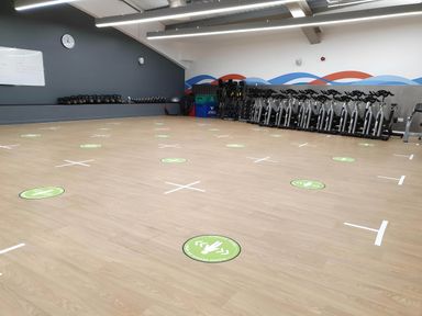 A gym room with exercise bikes kettlebells and social distancing markers on the floor at Lodge 58 - Oak Tree Lodge Finlakes Holiday Park near Chudleigh