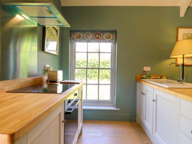 A kitchen with a stove and sink at Clock Tower in Stowmarket