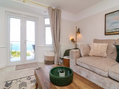 A living room with a sofa and coffee table at Combe View in Ilfracombe