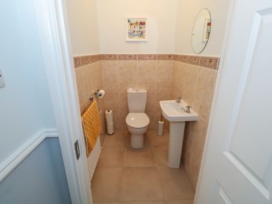 A bathroom with a toilet sink a mirror and a towel at Cois Leice Cushlecka near Mulranny County Mayo