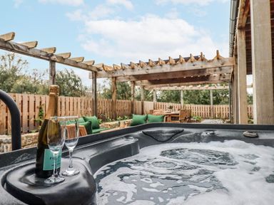An outdoor area with a hot tub and seating at Lower Moorwood Moorwood near Bovey Tracey