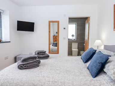 A bedroom with a bed and towels at Lower Moorwood in Moorwood near Bovey Tracey