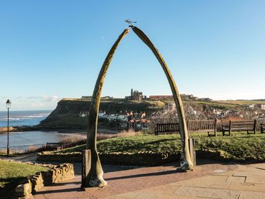A whale bone arch with benches at Juniper Lodge in Whitby
