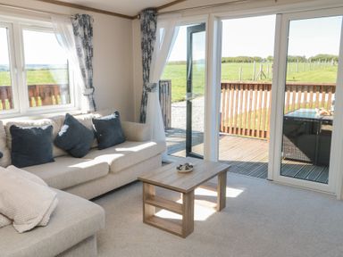 A living room with a sofa and coffee table at Magnolia Lodge in Whitby