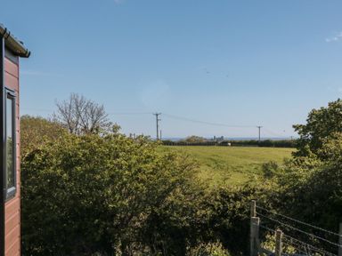 A view of a field and ocean at Magnolia Lodge in Whitby